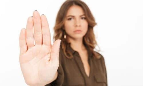Woman holding her hand up to indicate stop. Contact C. Woods Company in Tyler, TX for HVAC needs