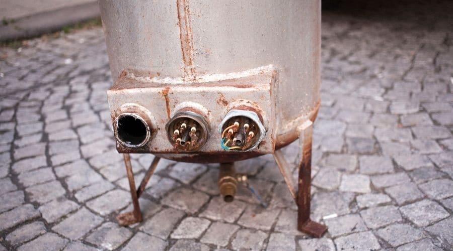 A rusted, old water tank being replaced by C. Woods Company in Tyler, TX.
