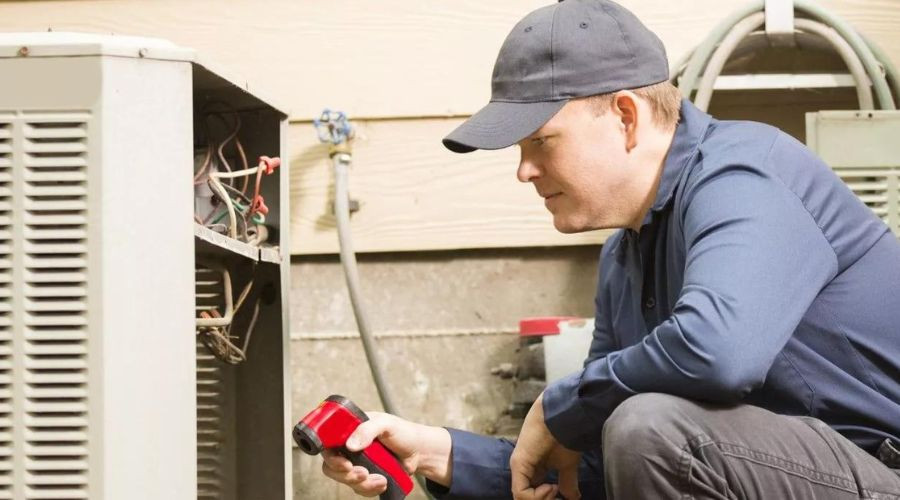 A C. Woods Company tech performing maintenance on an AC unit in Tyler, TX