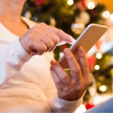 A woman on her cell phone in a comfortable home with HVAC service from C. Woods Company in Tyler, TX.