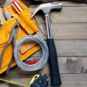 A yellow tool belt with an assortment of tools used by the techs at C. Woods Company in Tyler, TX.