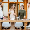 Two couples having dinner on the deck of a home. Call C. Woods Company in Tyler, TX for HVAC service