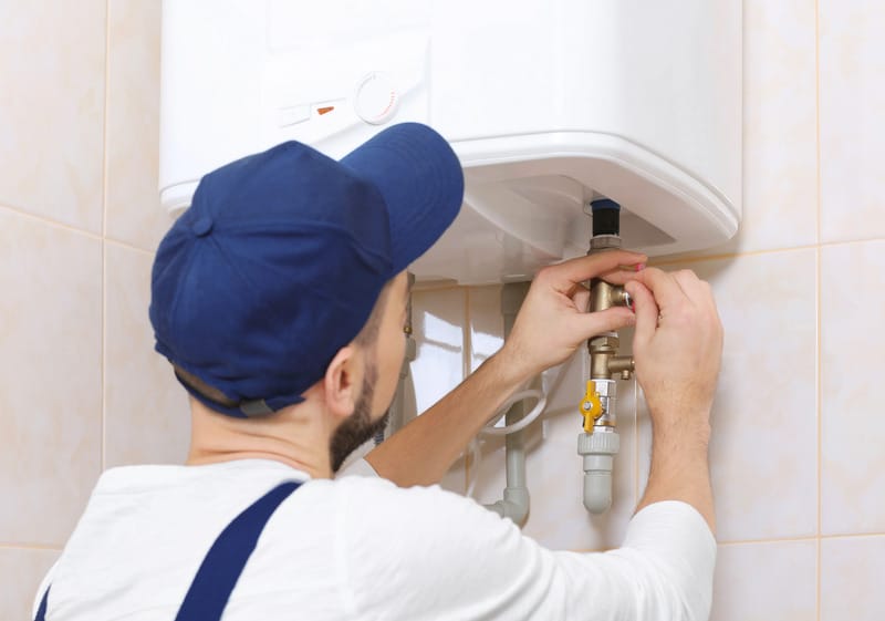 C. Woods Company technician working on tankless water heater in Tyler, TX