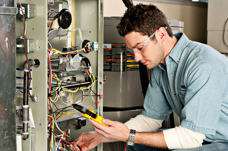 C. Woods Company HVAC technician repairing a furnace in Tyler, TX